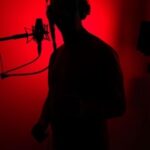 voice actor with microphone in shadows